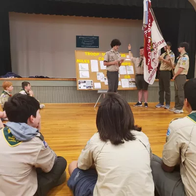 Scouts attend a meeting while scouts are sworn into new positions